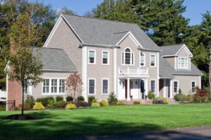 Large suburban home with gray shingle roofing