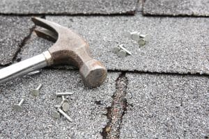 Repair of damaged asphalt shingle roof.