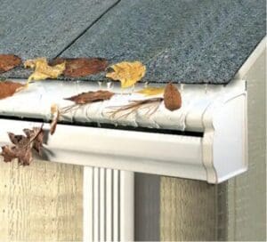 White rain gutter with gutter cover to prevent leaf blockage.