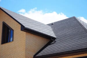 Gray shingle roof on a brick house