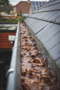 Clogged rain gutters full of leaves