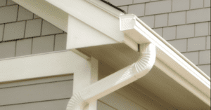 White rain gutter with downspout